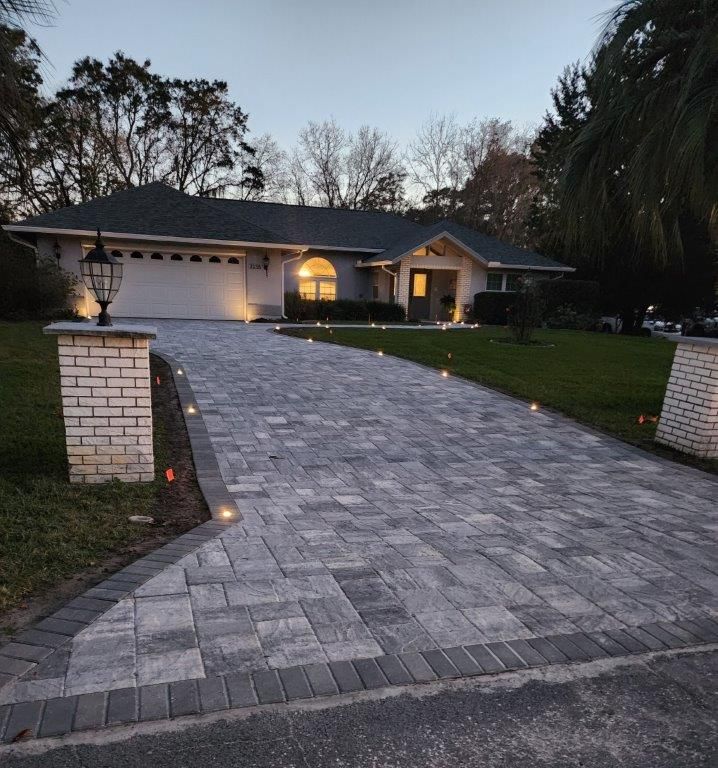 A house with a brick driveway leading to it
