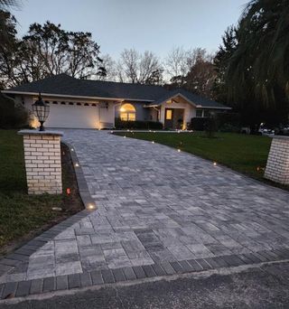 A house with a brick driveway leading to it