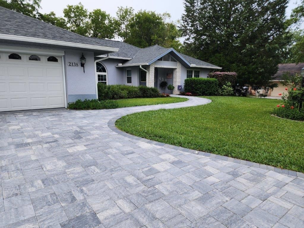 A house with a driveway leading to it and a garage.