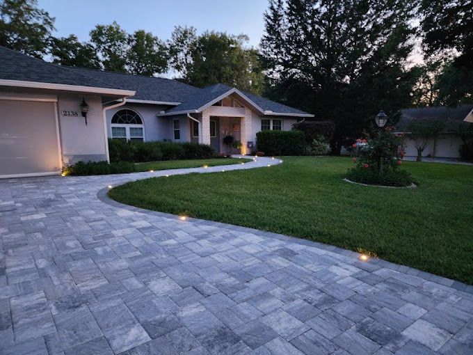 A house with a brick driveway leading to it