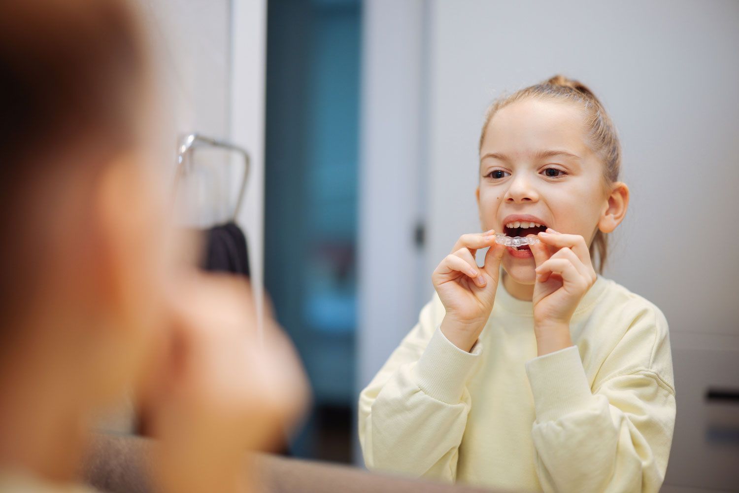 Little Girl Holding Invisible Dental Aligners Little Girl Holding Invisible Dental Aligners