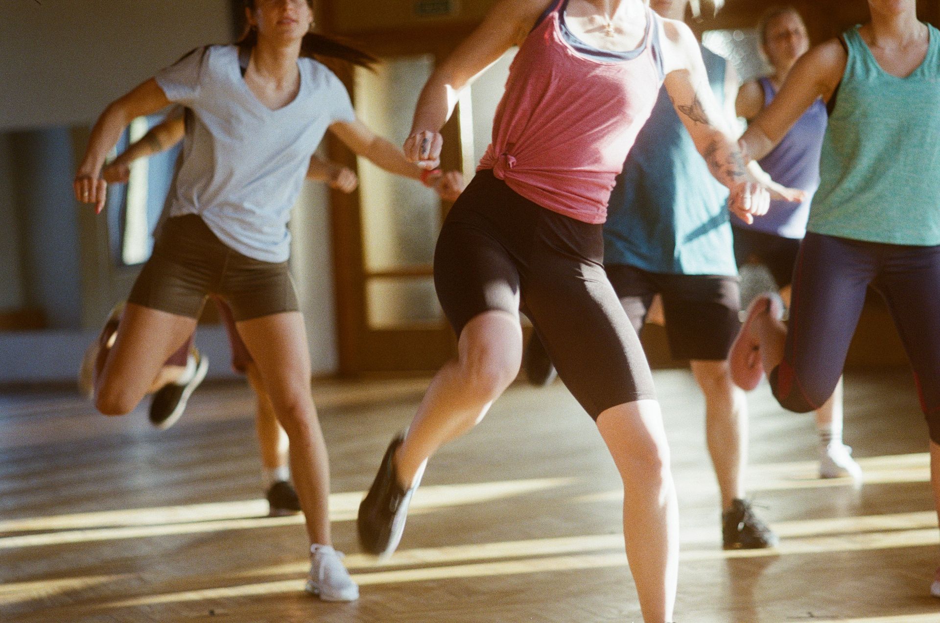 A group of young women are dancing together in a gym.