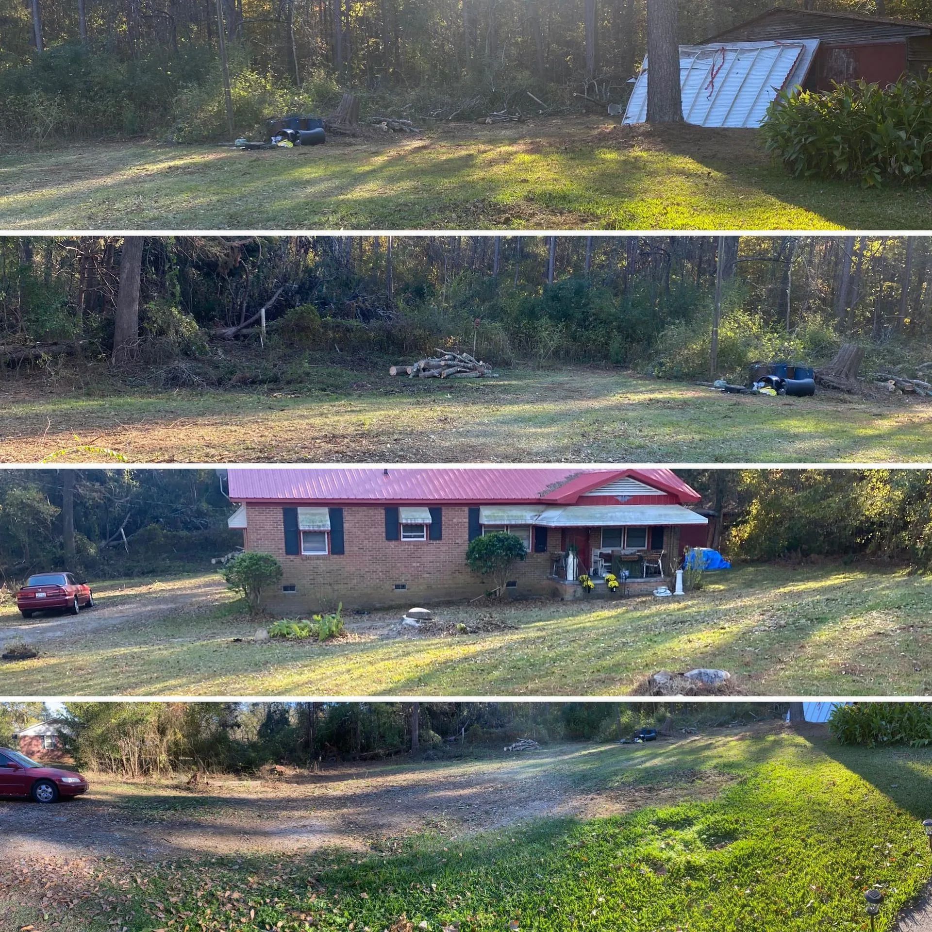 A brick house with a red roof, a car, and green grass against a wooded backdrop.