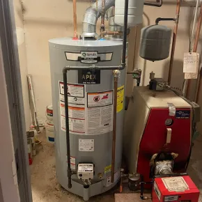 Apex Climate Control - A blue water heater is next to a gray water heater