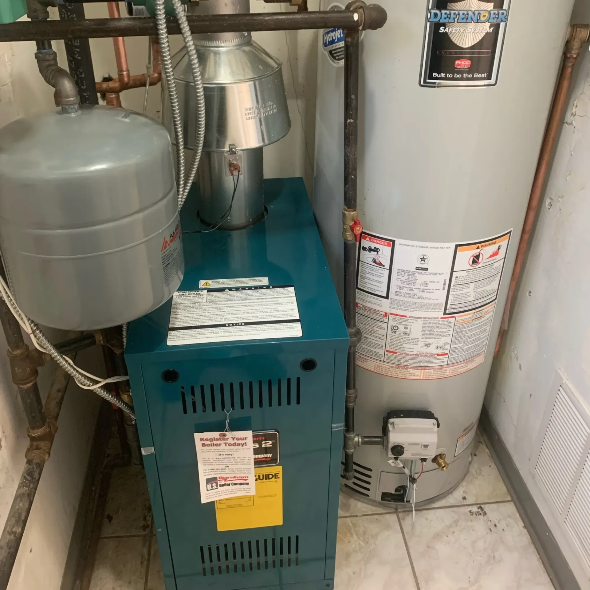  Apex Climate Control - A blue water heater is next to a gray water heater