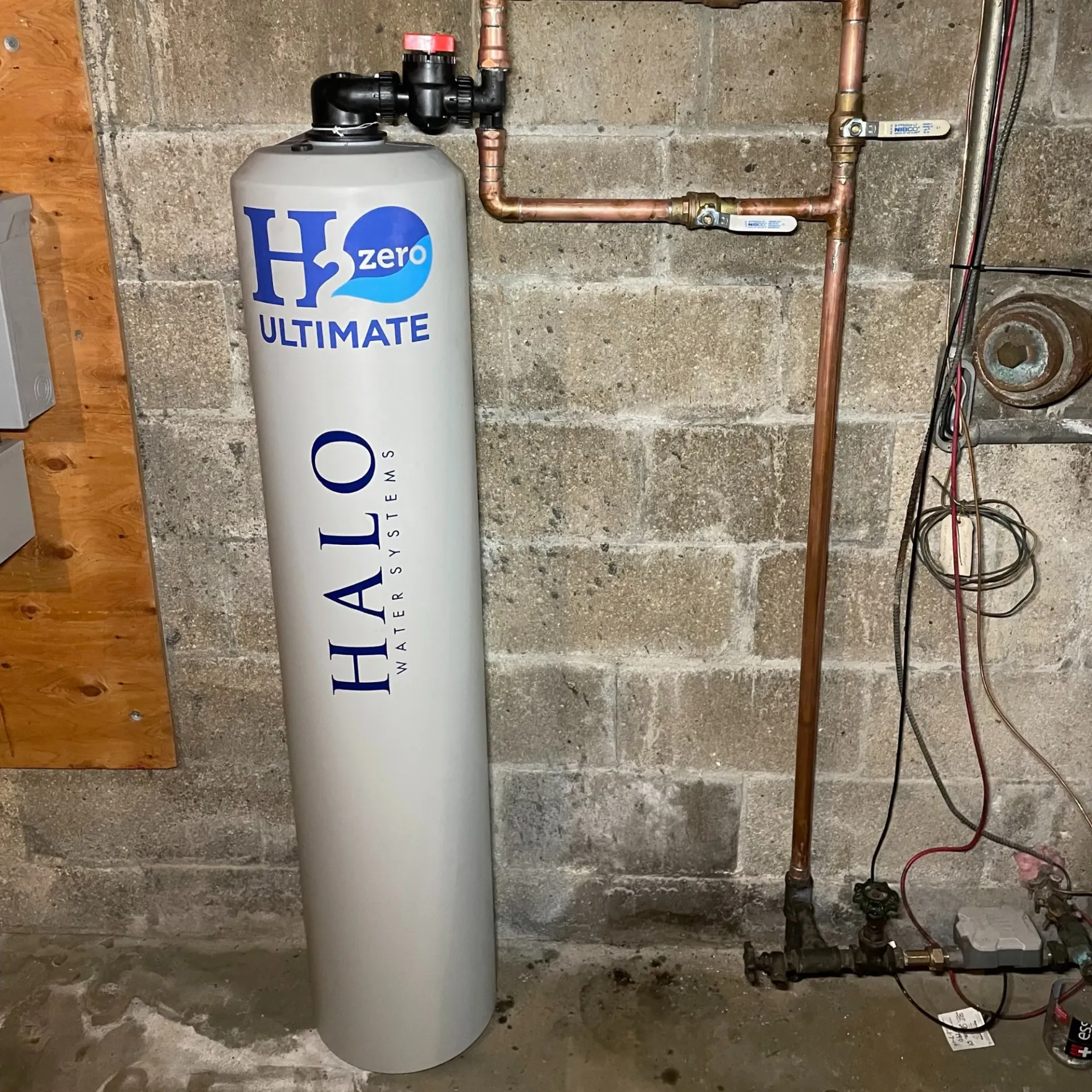 Apex Climate Control - A halo water filter is sitting in a basement next to a brick wall.