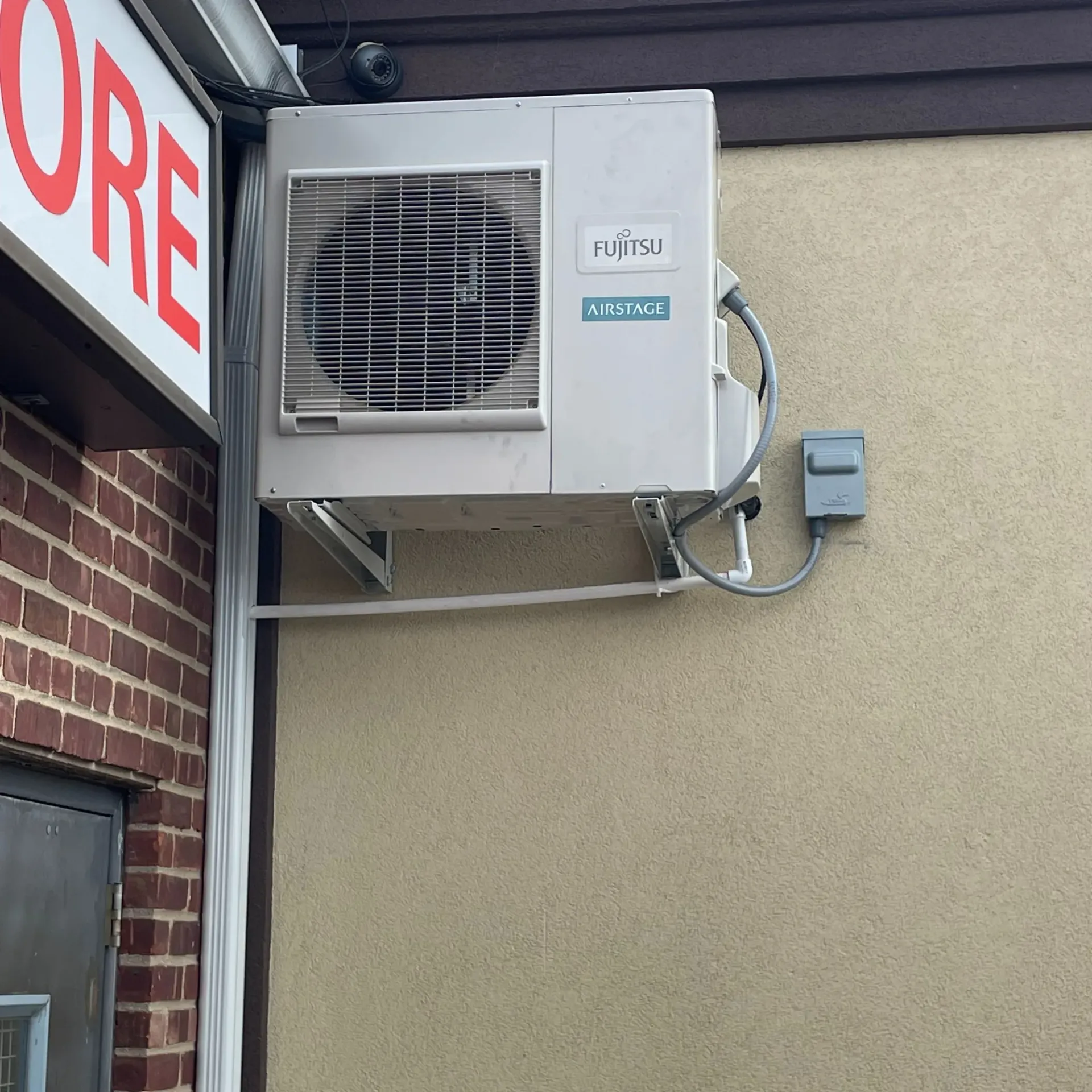 Apex Climate Control - A fujitsu air conditioner is mounted on the side of a building