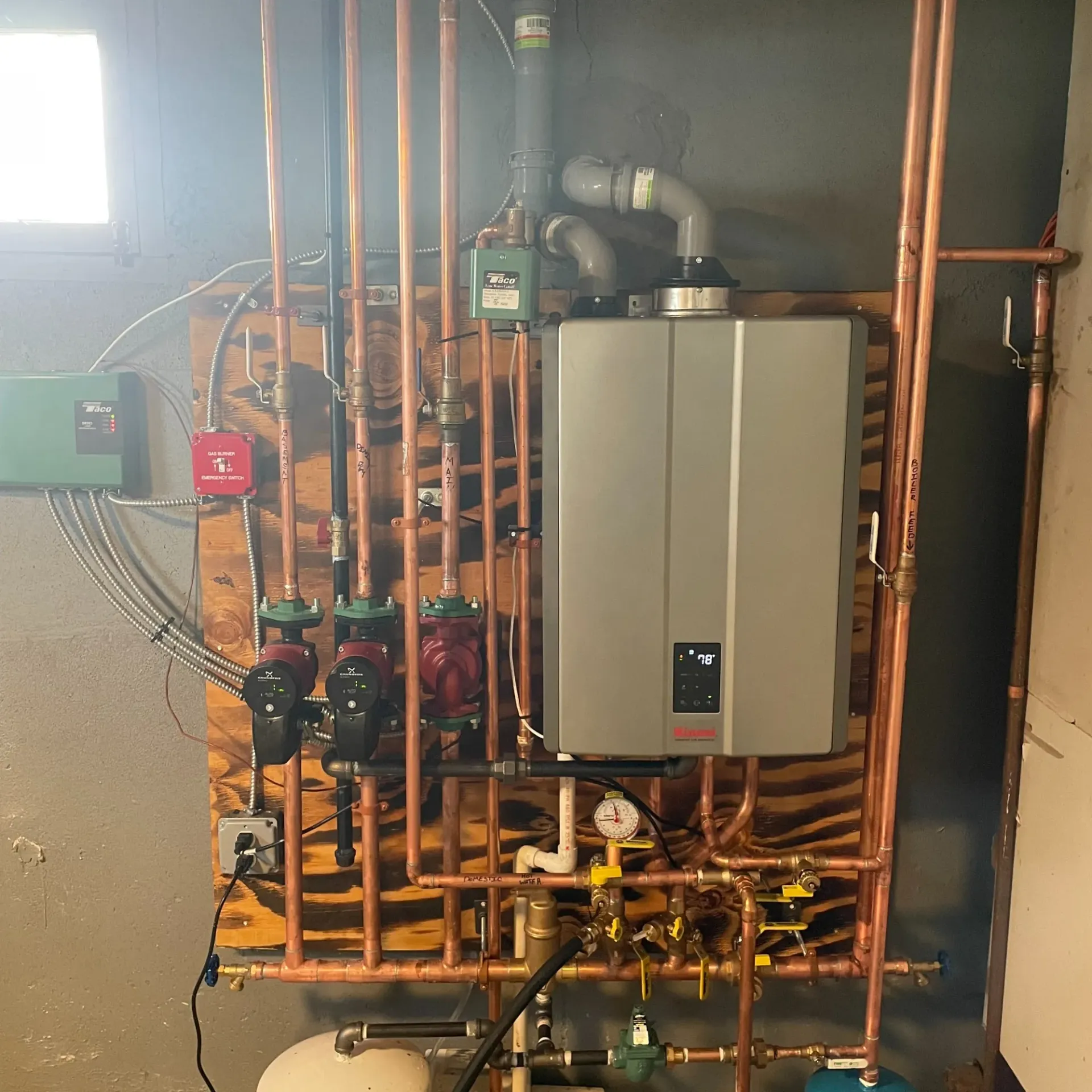 Apex Climate Control - A water heater is surrounded by copper pipes in a room.