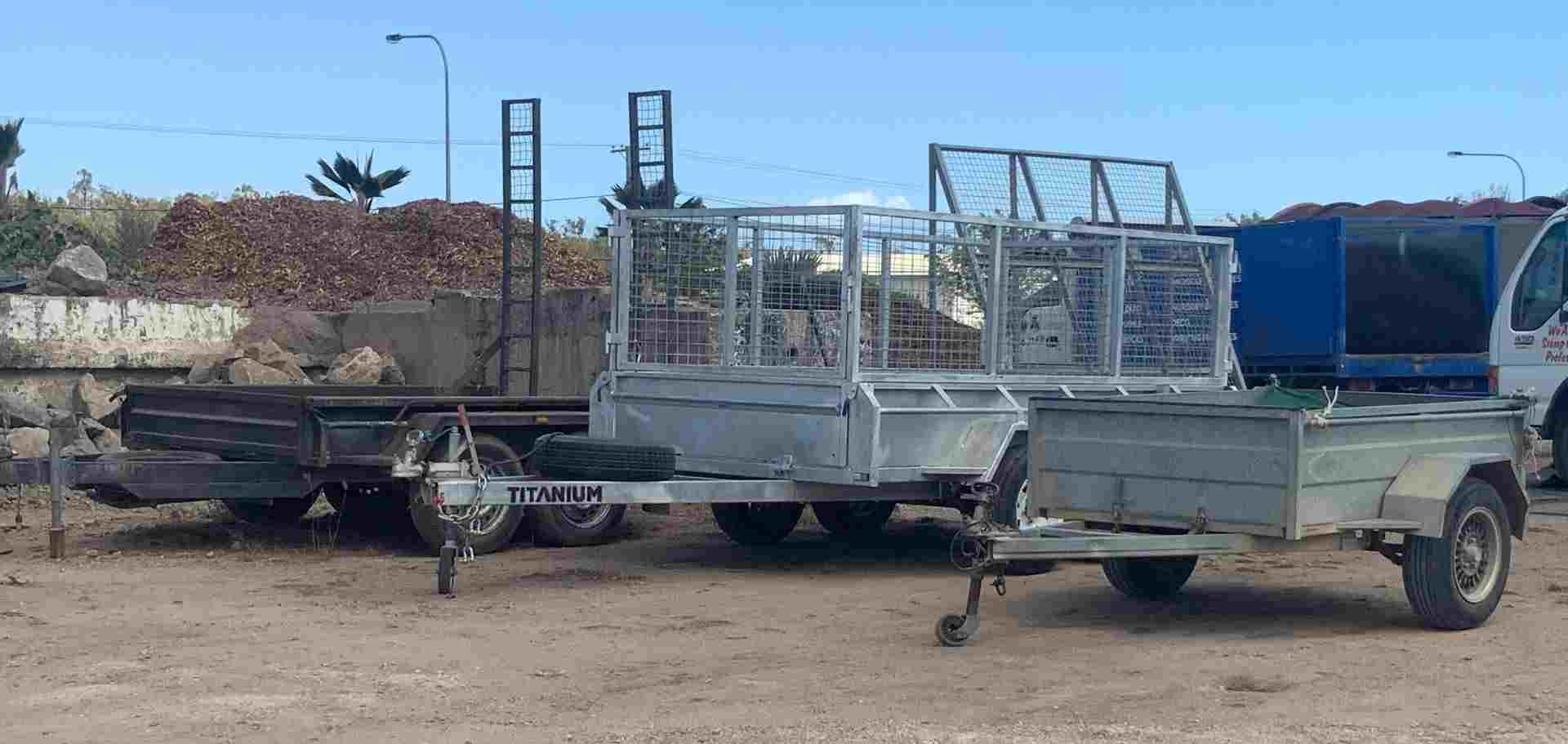 Two Trailers Are Parked Next to Each Other in a Dirt Lot — Scott Kennedy's Landscape & Garden Supplies In Shaw, QLD