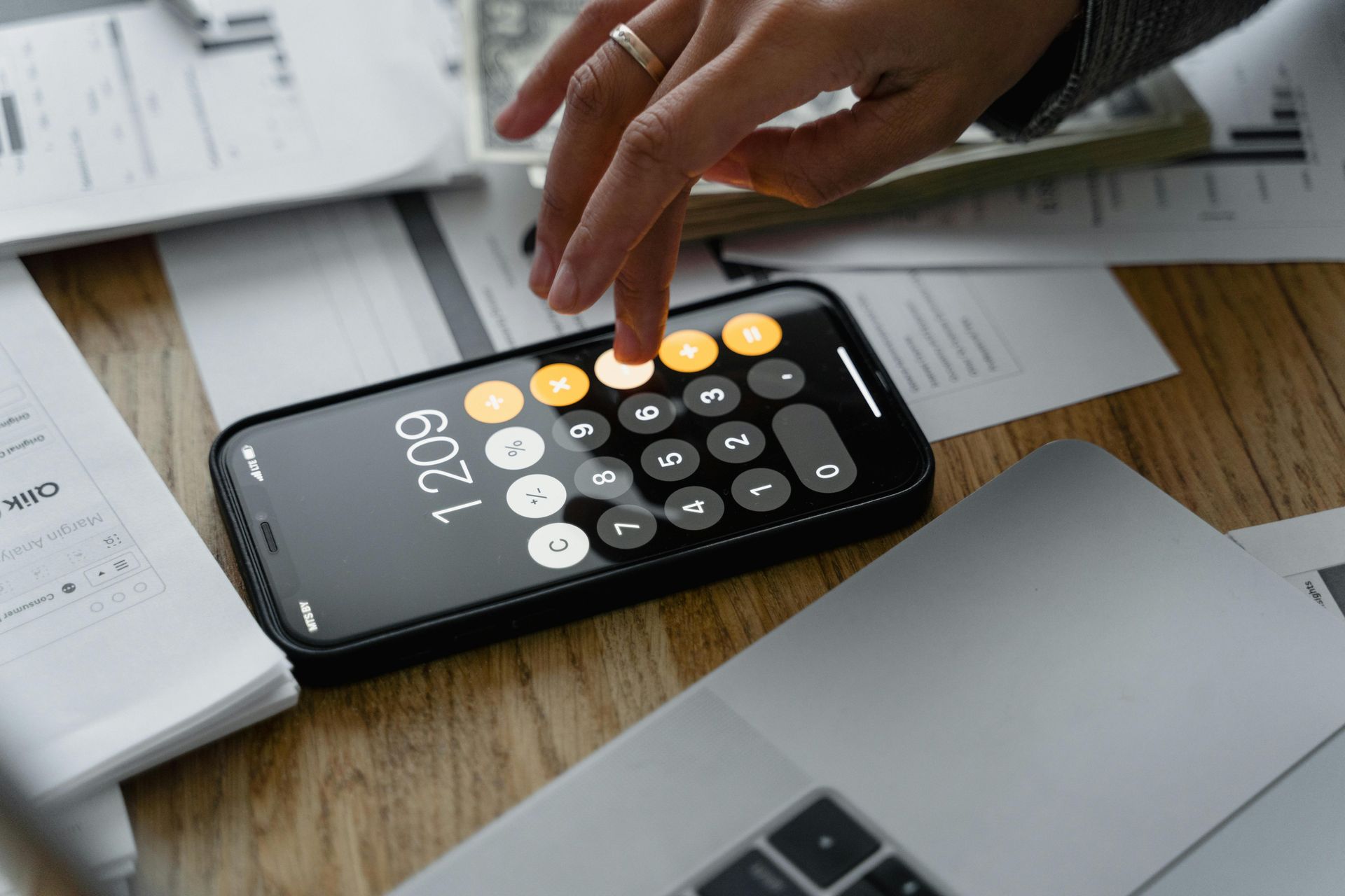 A person is using a calculator on a cell phone.