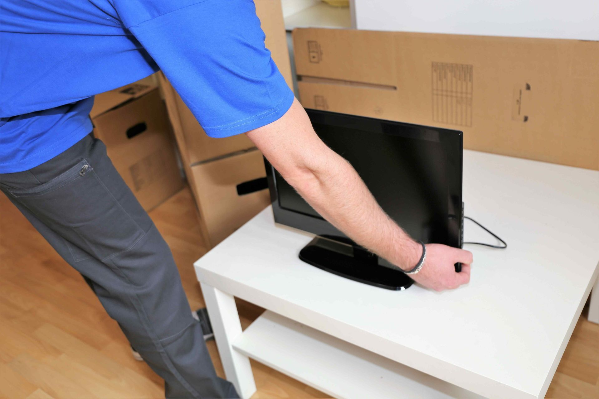 a mover is placing a screen on a white desk