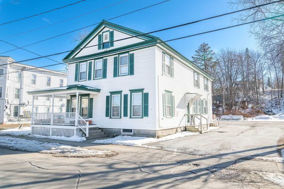 White two-story house rental property in Sugar Hill, NH by Loveless Family Properties
