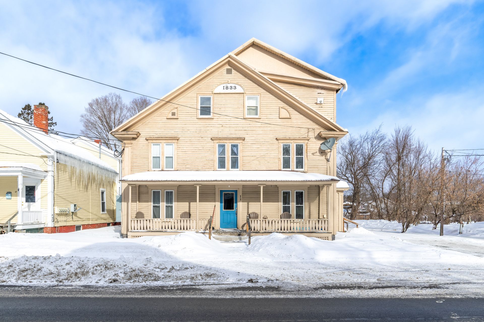Three-story light-colored wooden house rental property in Bethlehem, NH by Loveless Family Properties