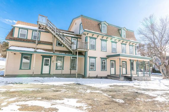 White two-story house rental property in Sugar Hill, NH by Loveless Family Properties