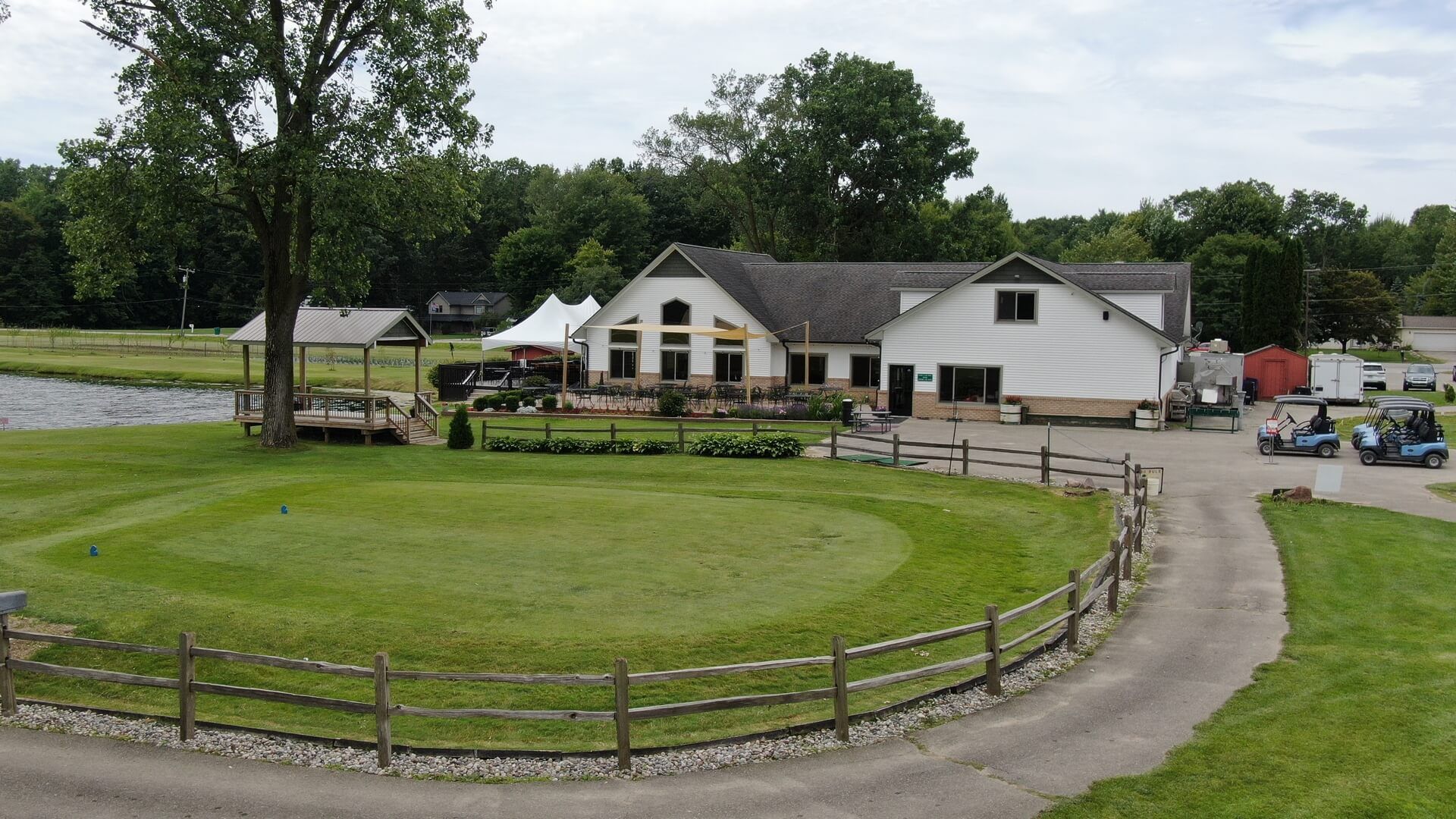 A golf course with a house in the background.