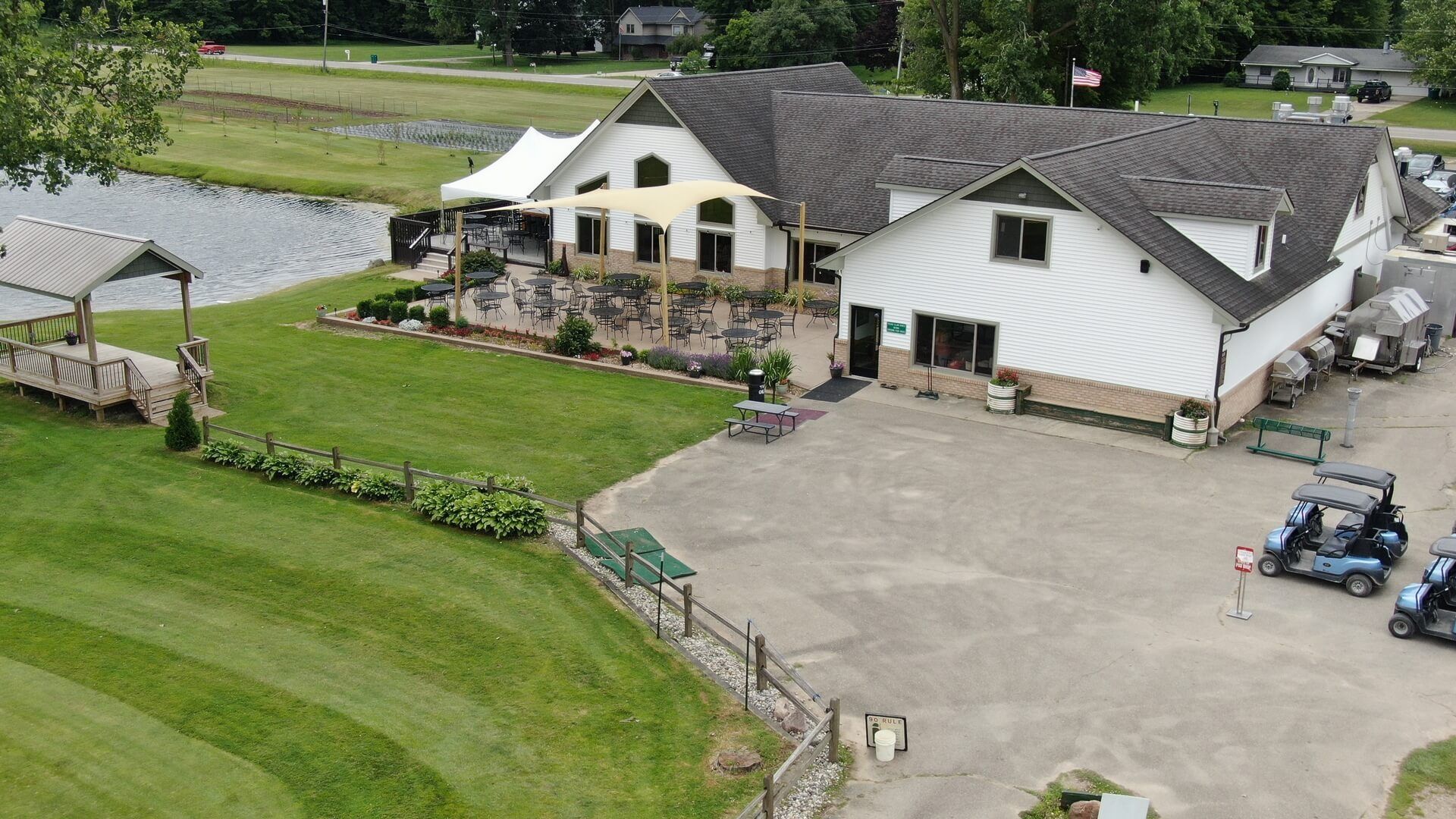 An aerial view of a house with a golf cart parked in front of it.