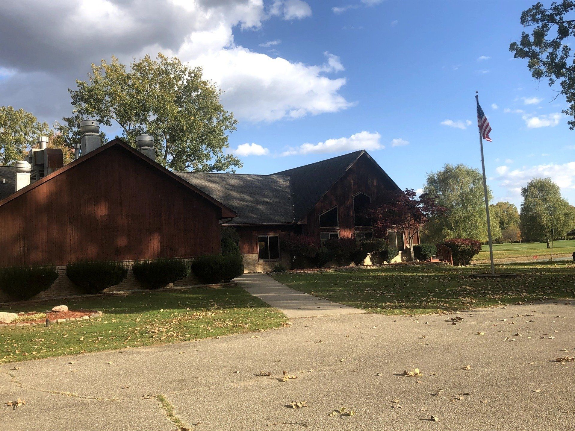 A large house with a flag in front of it.