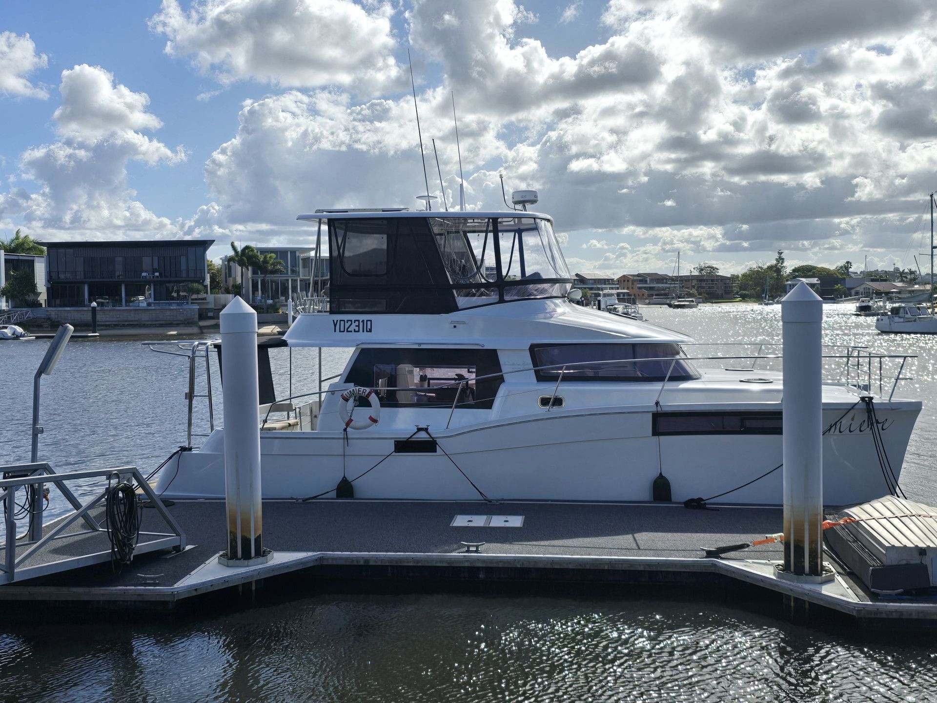 A Boat Is Docked At A Dock In The Water — The Boat Cover Company In Buddina, QLD