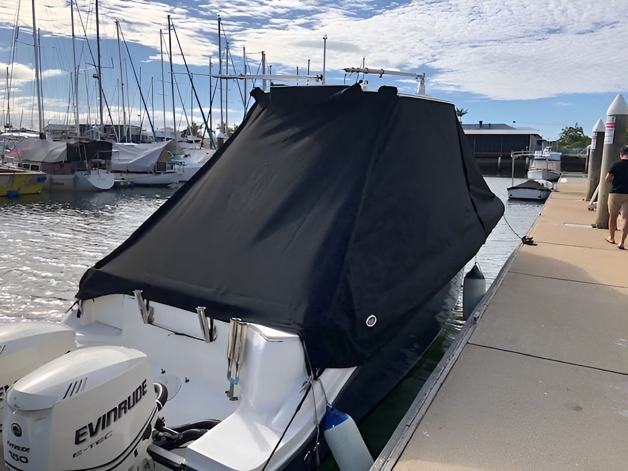 Black-covered Boat Docked at a Marina With Two Outboard Motors — The Boat Cover Company In Buddina, QLD