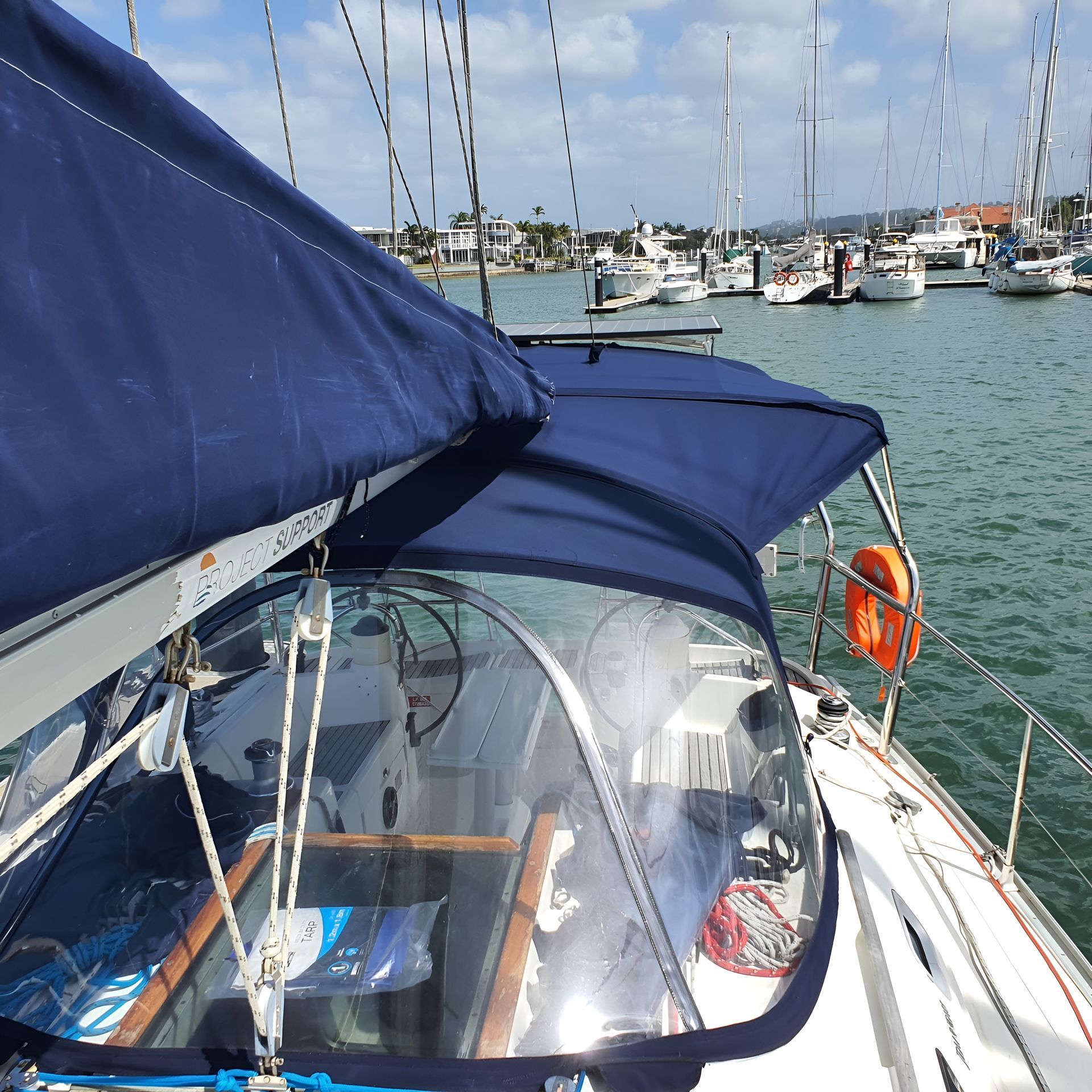 Sailboat Cockpit With Blue Canvas, Clear Enclosure, and Harbor — The Boat Cover Company In Buddina, QLD