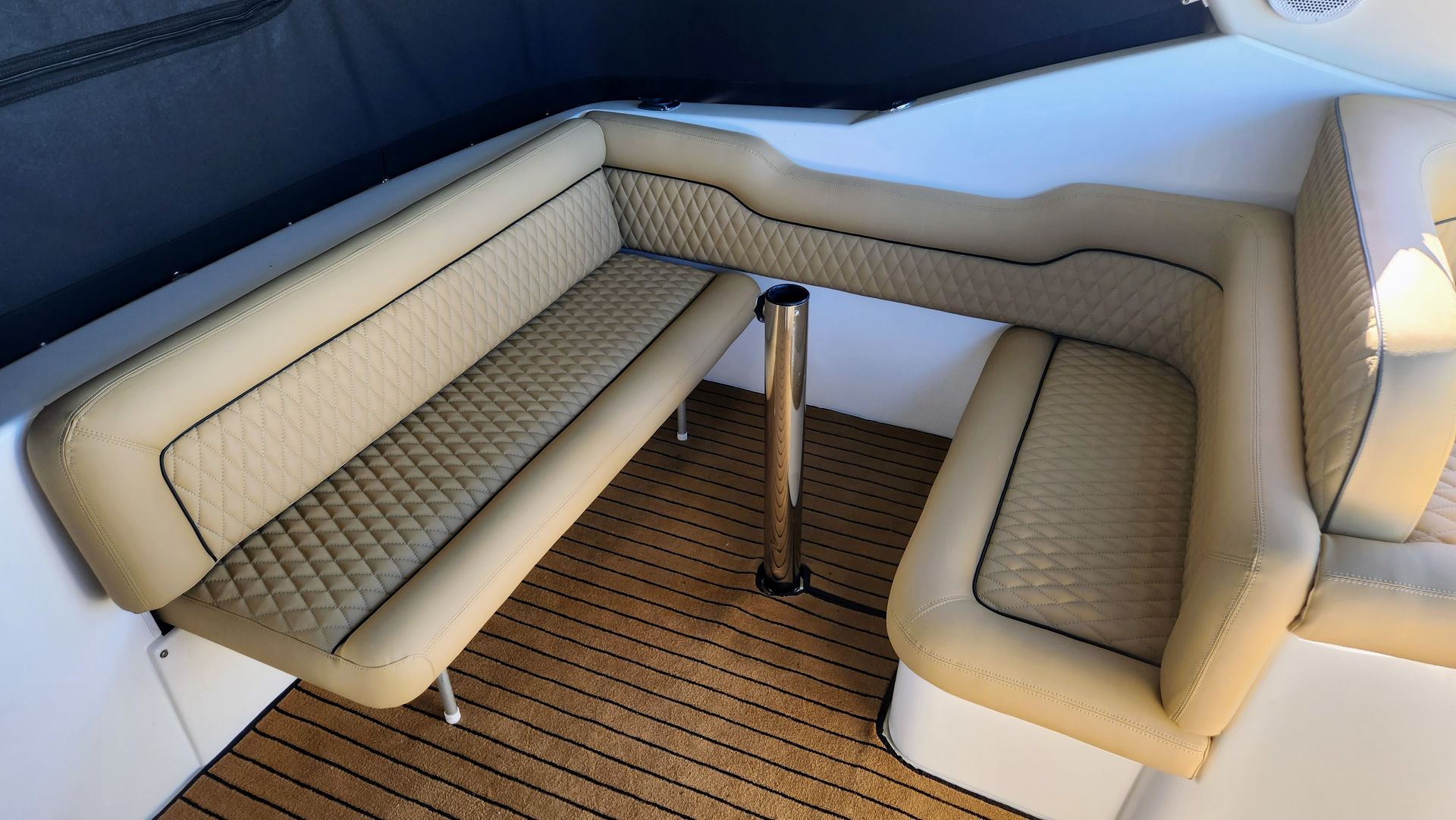 A boat with a couch and a table on the deck. The Boat Cover Company In Buddina, QLD