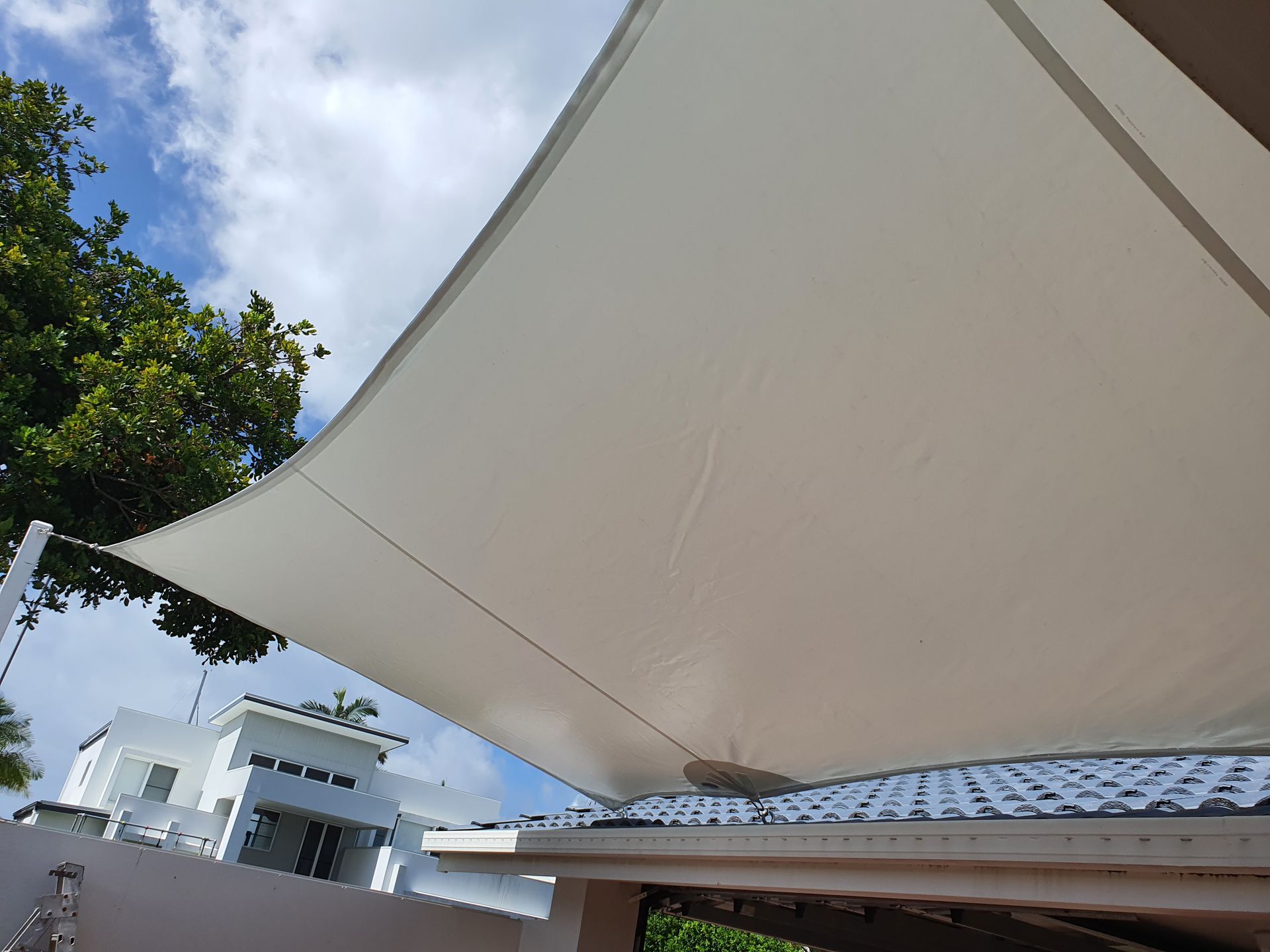 Off-white Shade Sail Covering a Roof on a Sunny Day — The Boat Cover Company In Mooloolaba, QLD