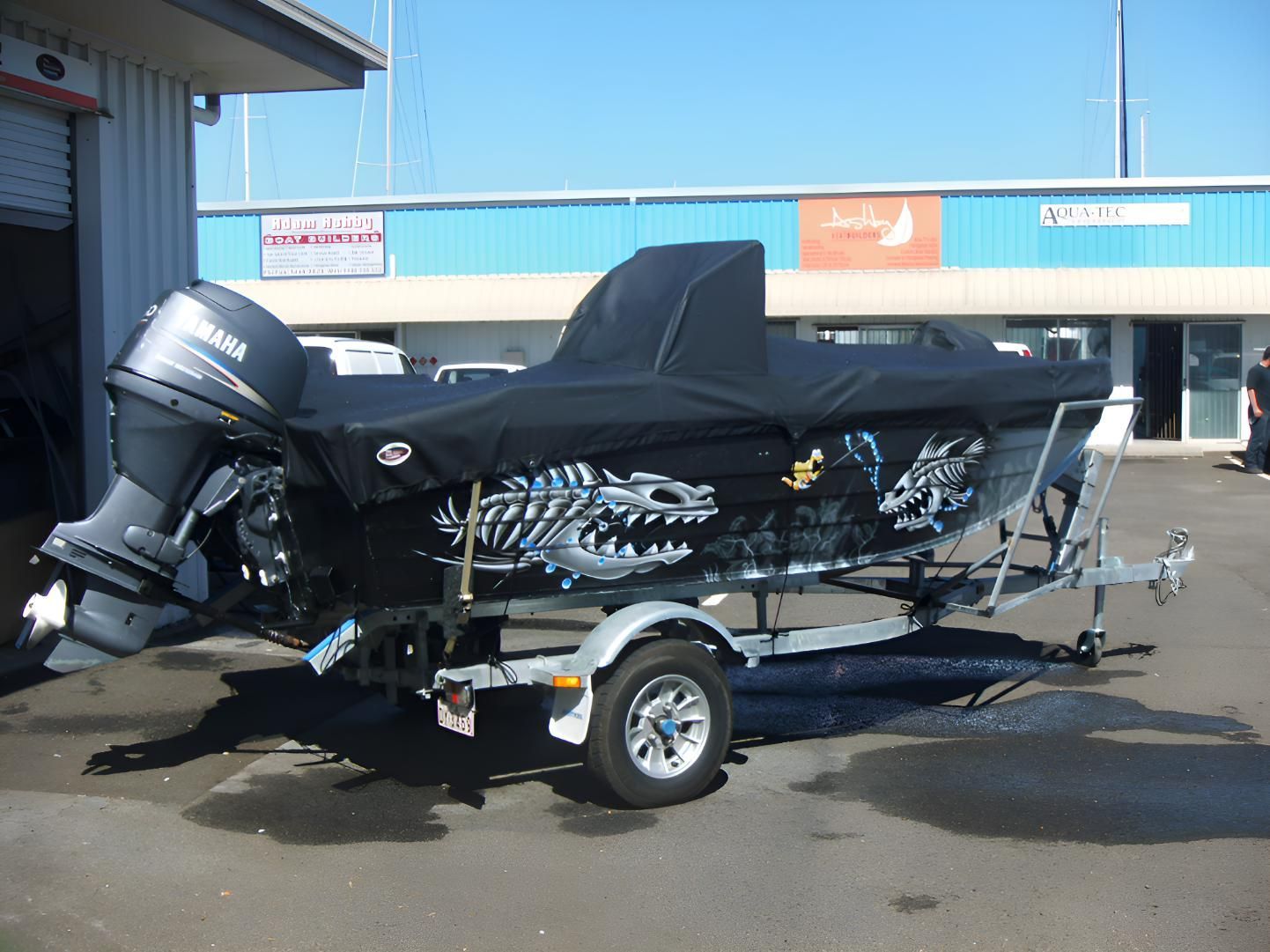 A Yamaha Boat is on a Trailer in Front of a Building — The Boat Cover Company In Mooloolaba, QLD