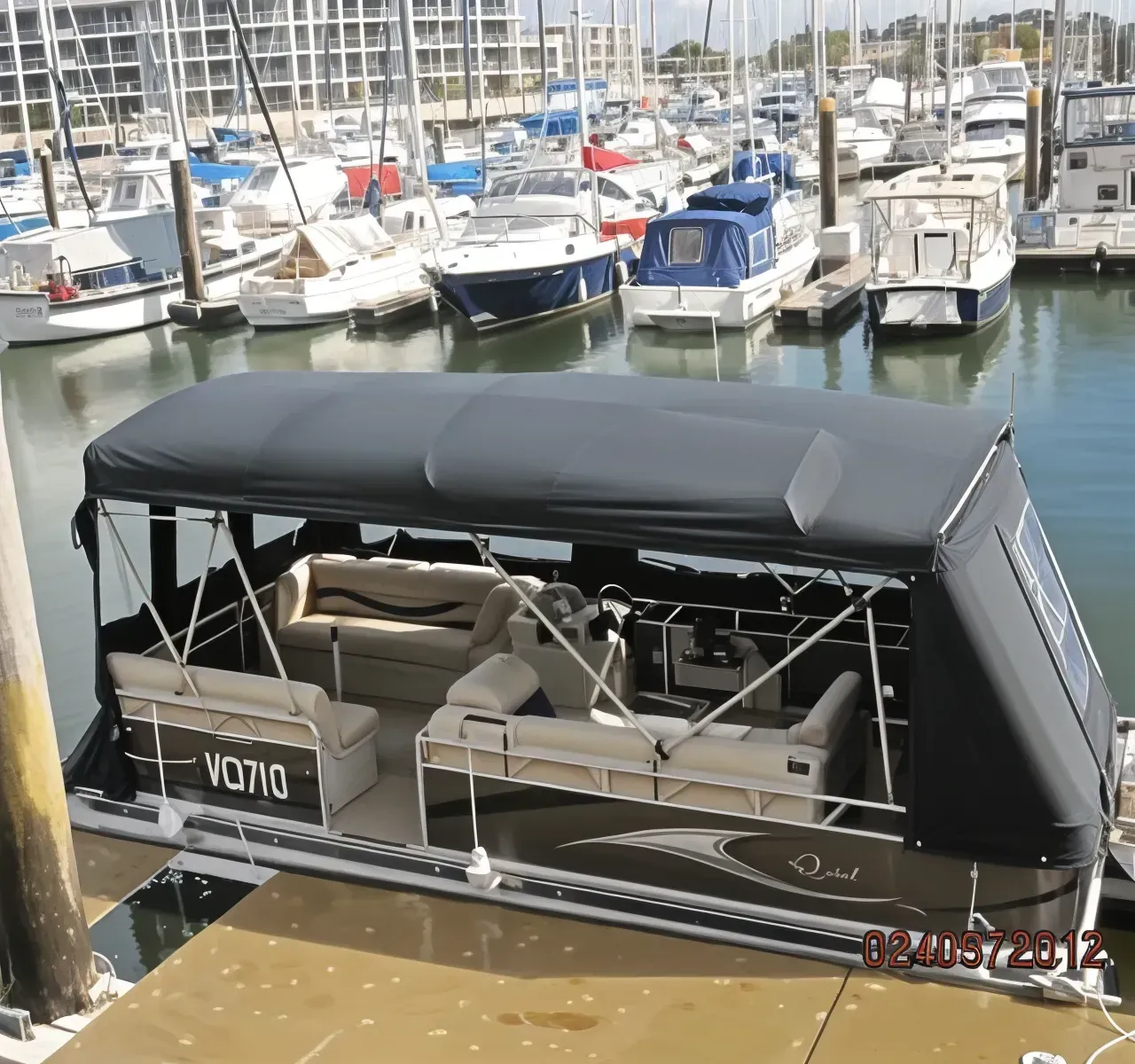 Pontoon Boat Docked in a Marina, With Black Canopy — The Boat Cover Company In Buddina, QLD