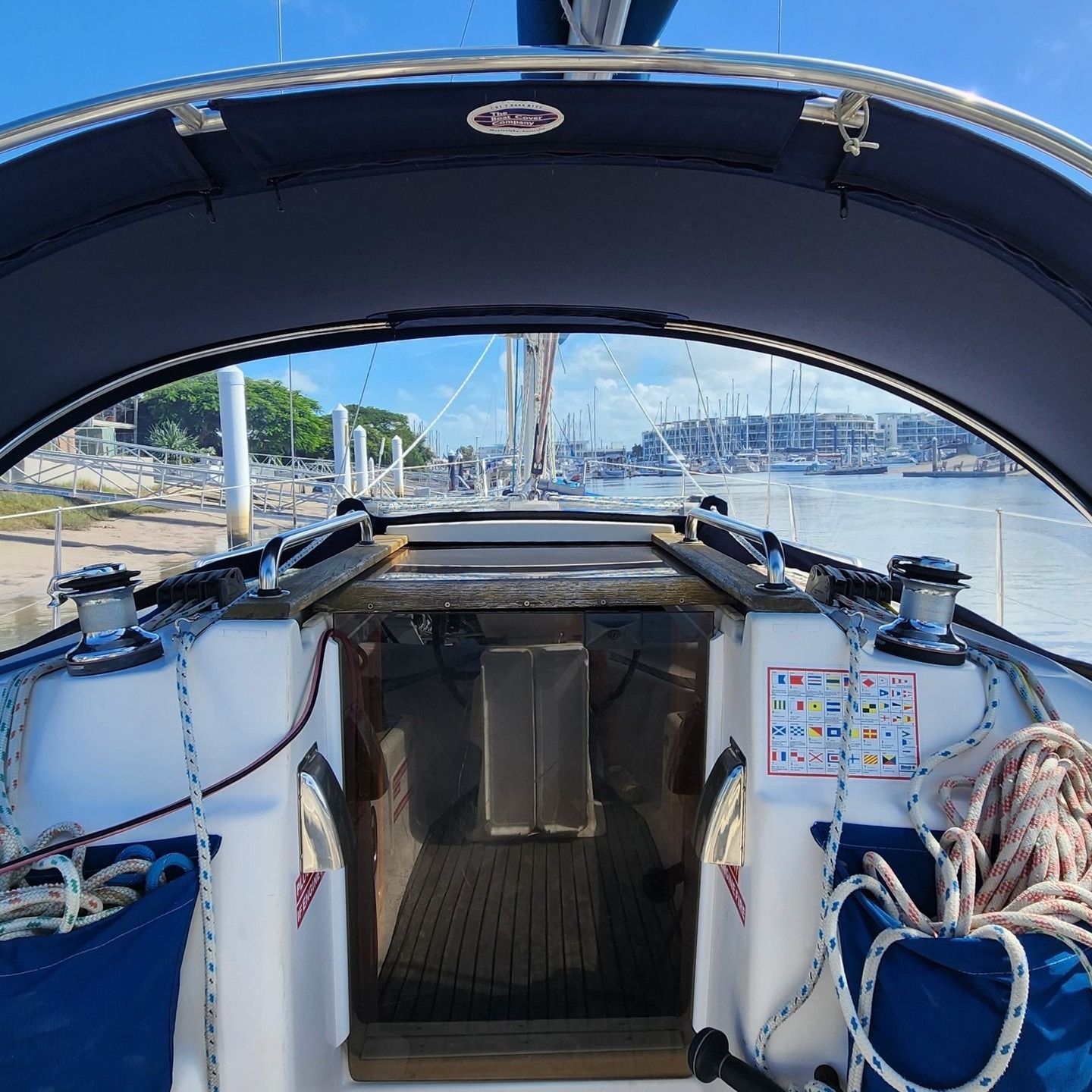 View From the Cockpit of a Sailboat Looking Out at a Harbor on a Sunny Day — The Boat Cover Company In Buddina, QLD