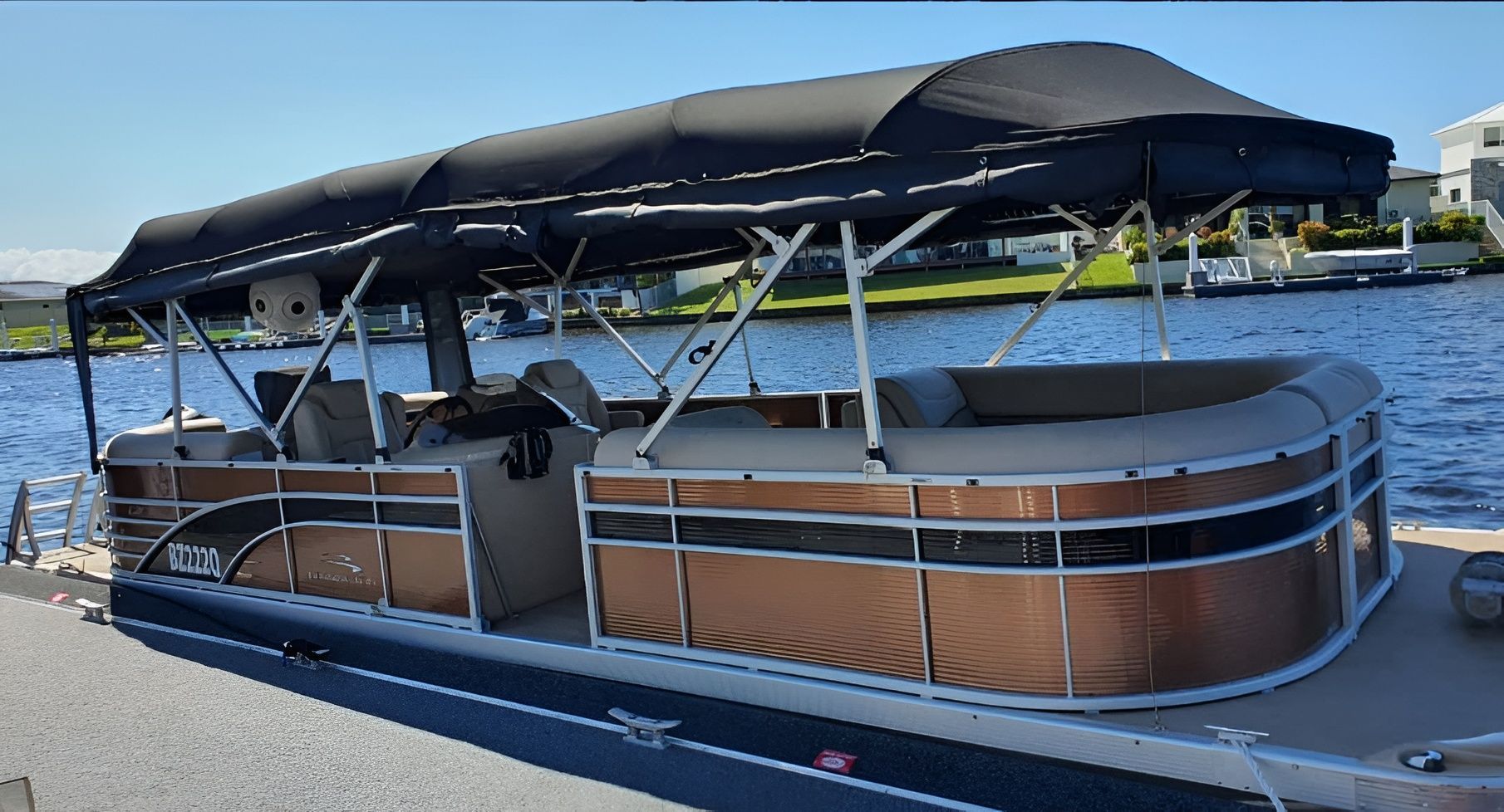 Pontoon Boat With Black Canopy on a Lake — The Boat Cover Company In Buddina, QLD