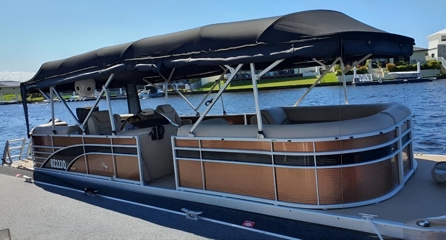 A Pontoon Boat With A Black Canopy — The Boat Cover Company In Buddina, QLD