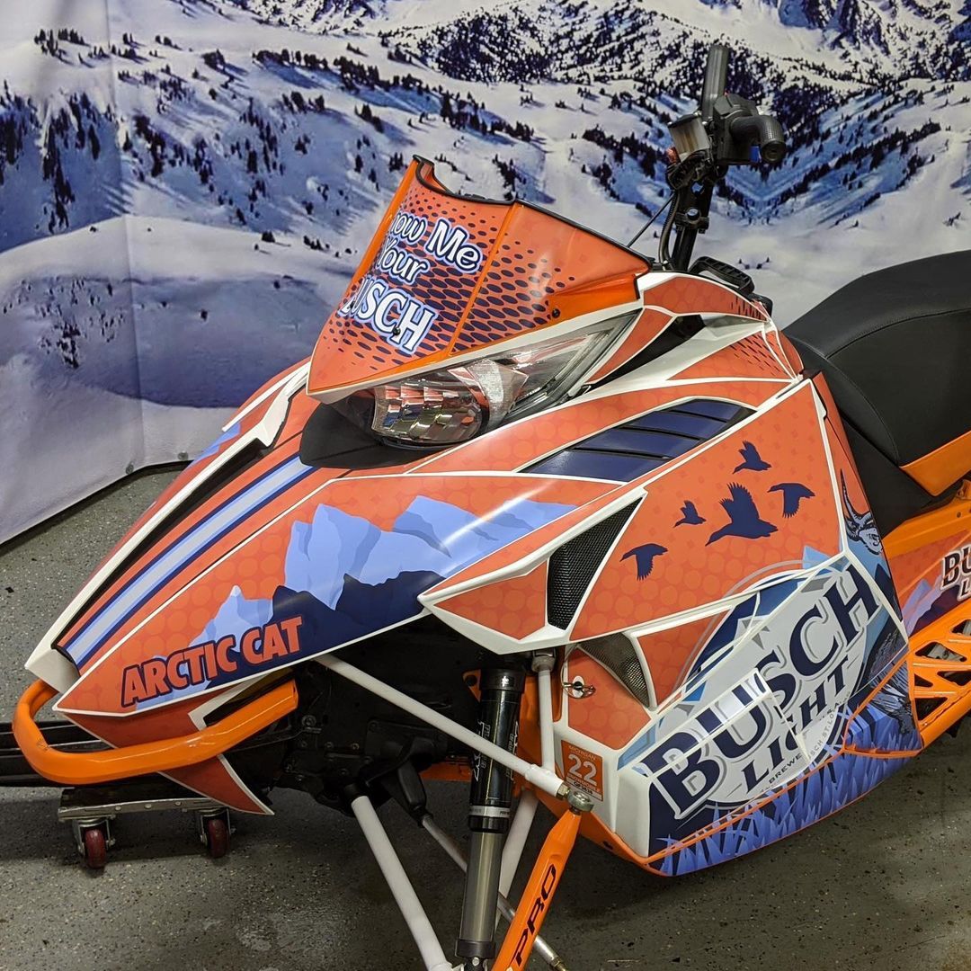 A snowmobile with the word arctic cat on it