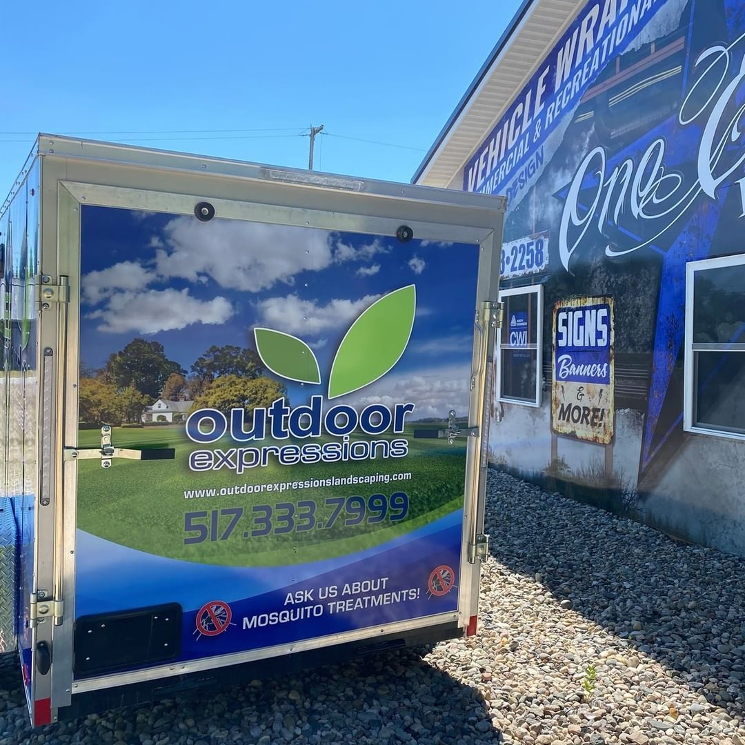 A trailer is parked in front of a building that says outdoor engineering.