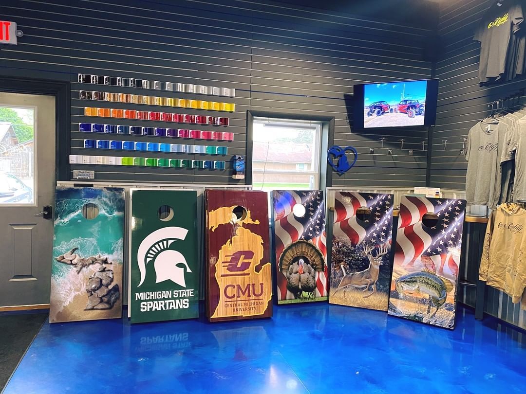 A bunch of cornhole boards are sitting on a table in a room.