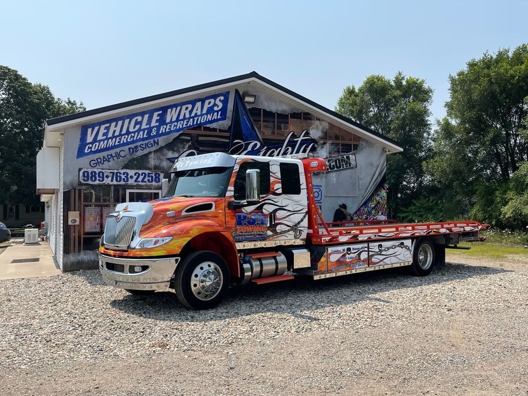 A tow truck is parked in front of a building.