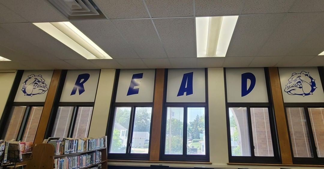 A library with a sign that says read on the windows