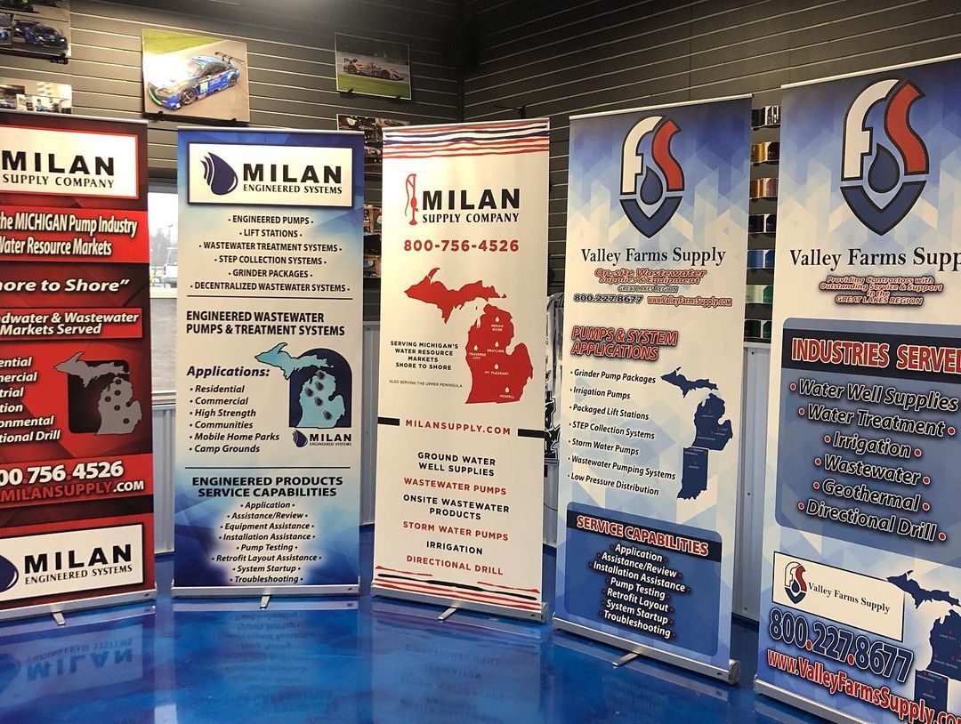 A bunch of banners are sitting on a table in a room.