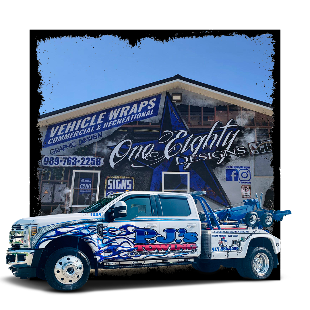 A white tow truck is parked in front of a building.