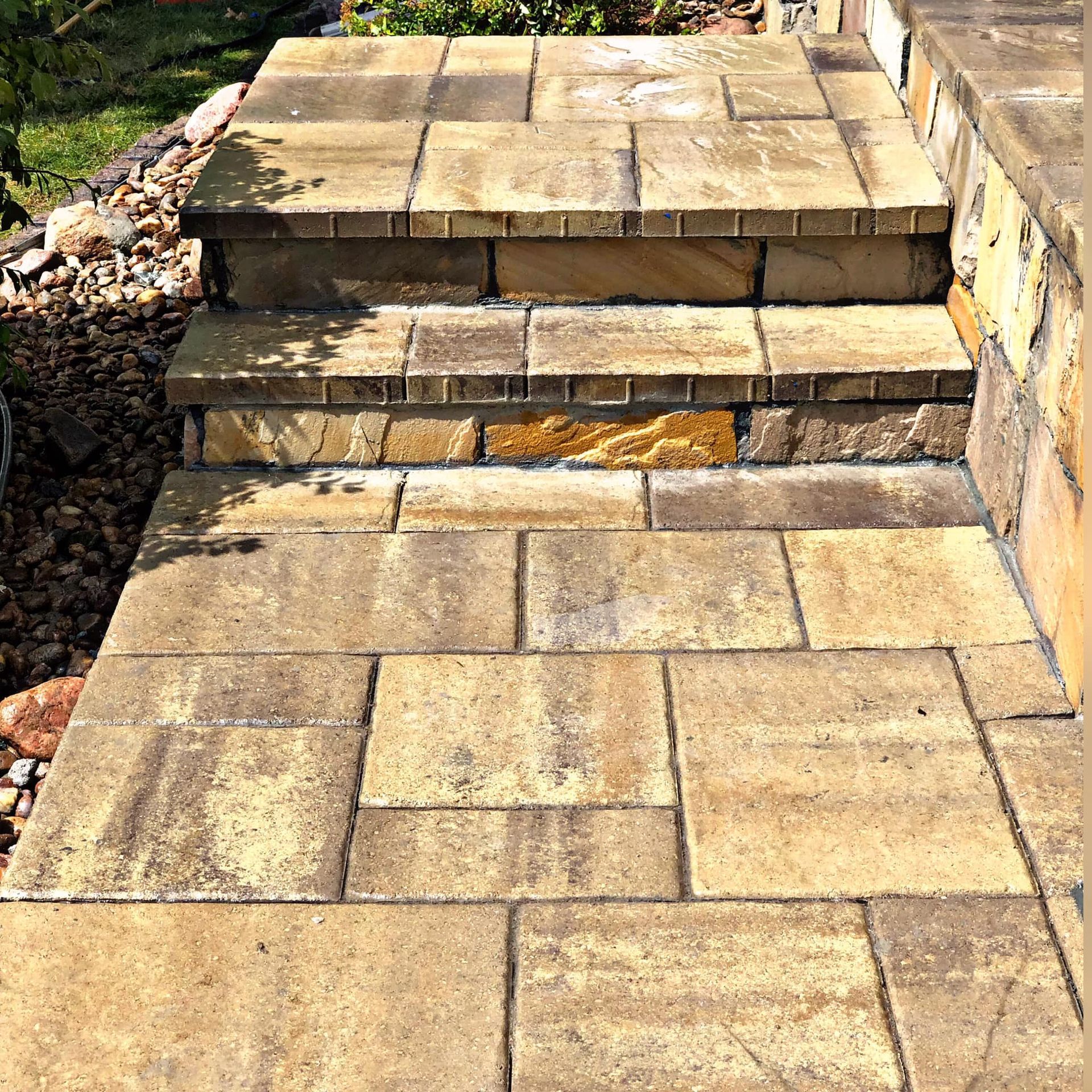 Stone steps leading up to a higher level, with a pathway of matching stone blocks.