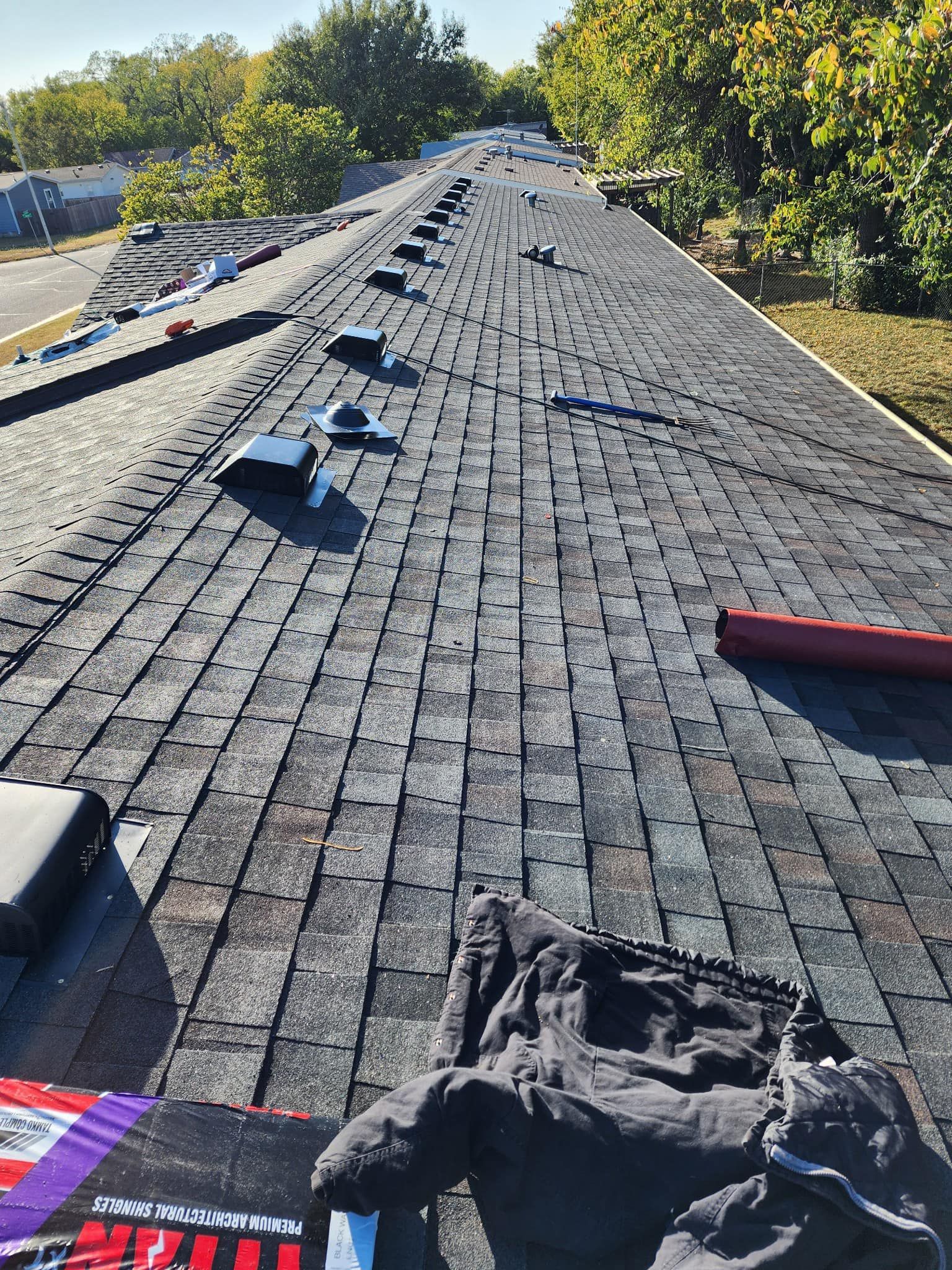 A person is standing on the roof of a building.