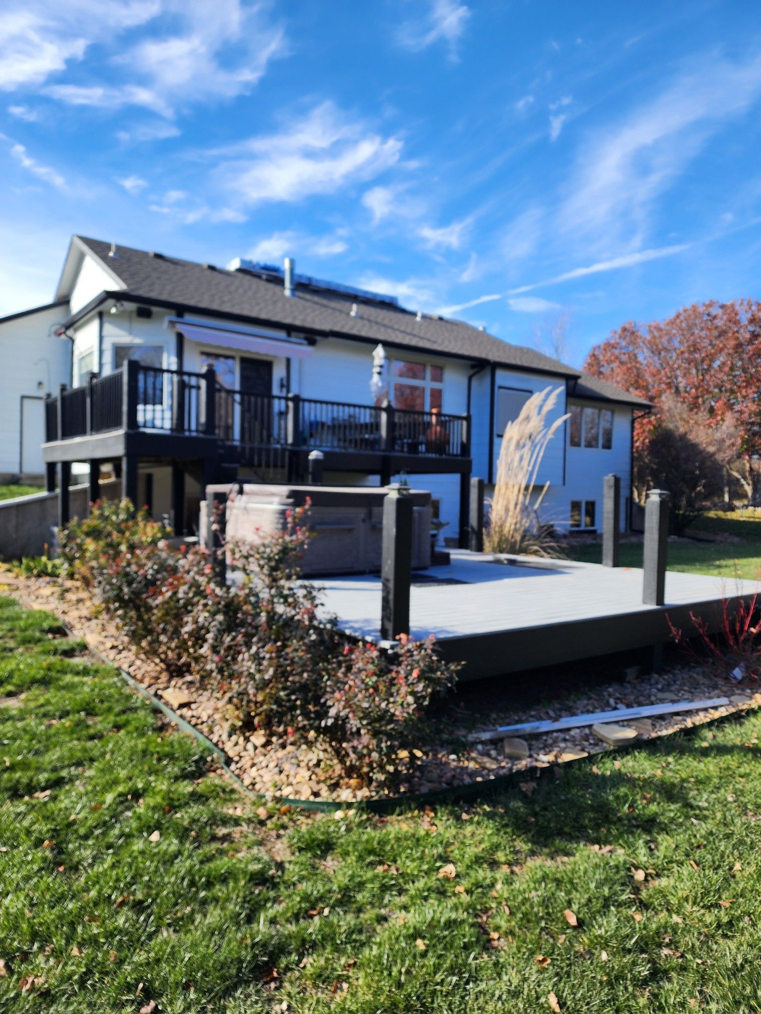 A large house with a large deck in front of it.