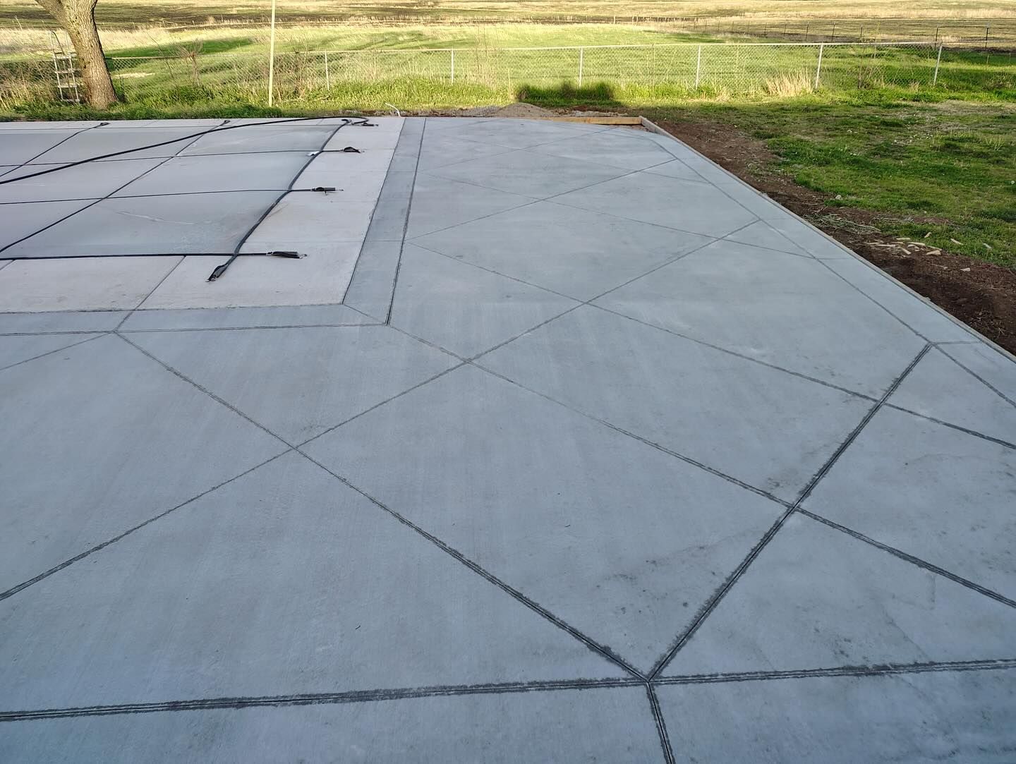 A concrete driveway with a geometric pattern on it