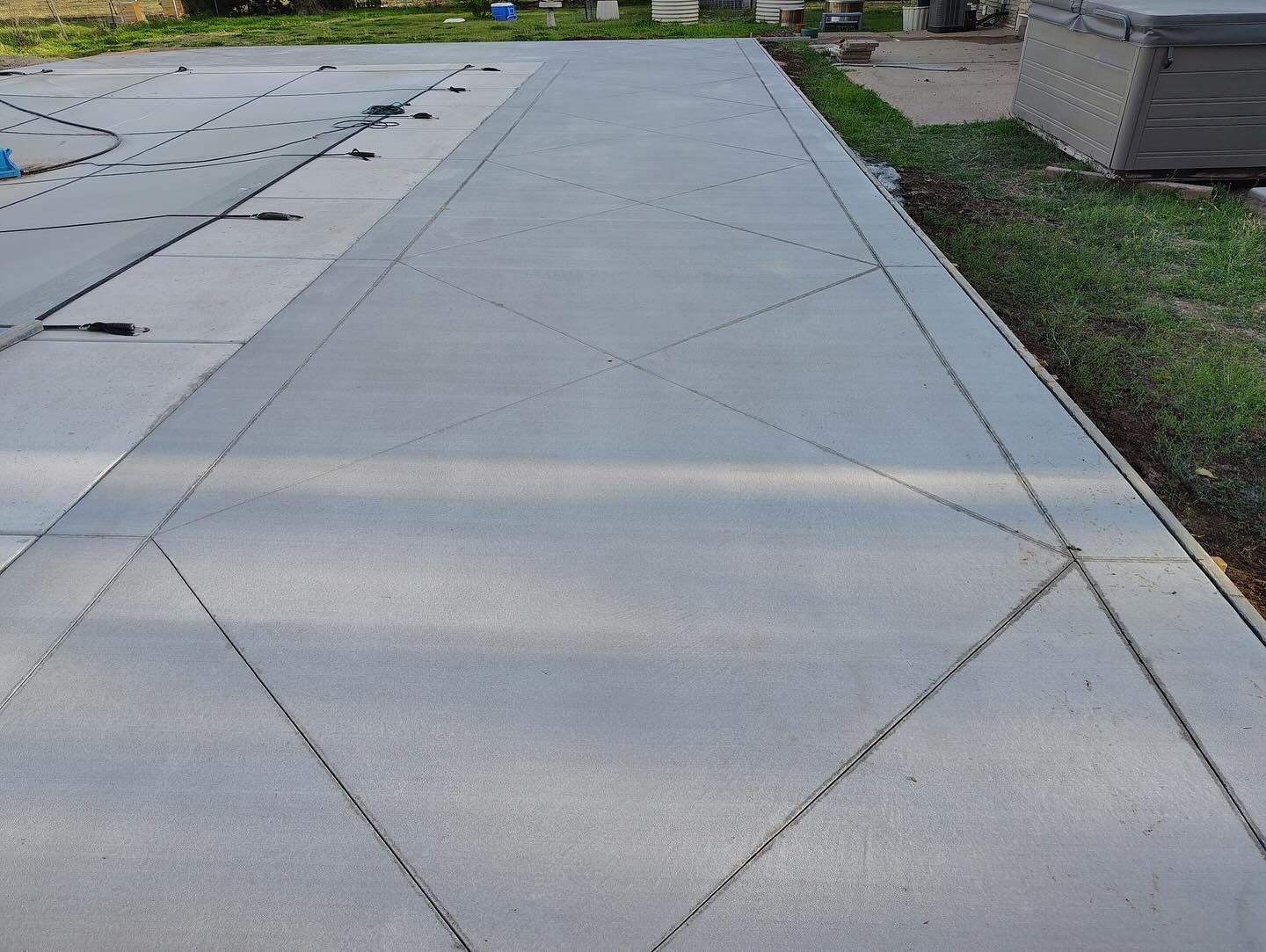 A concrete driveway with a diamond pattern on it is being built.