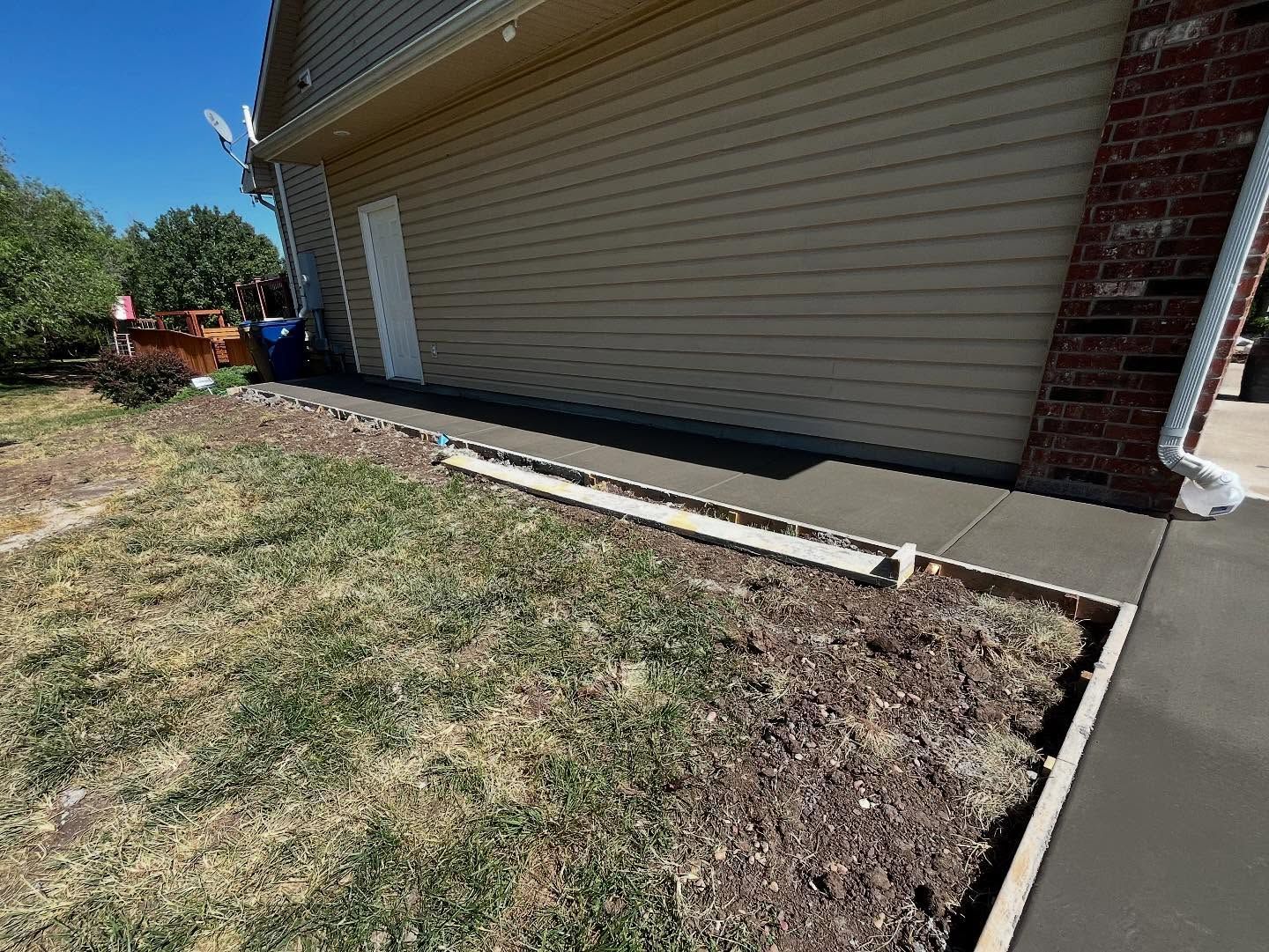 concrete walkway along house 