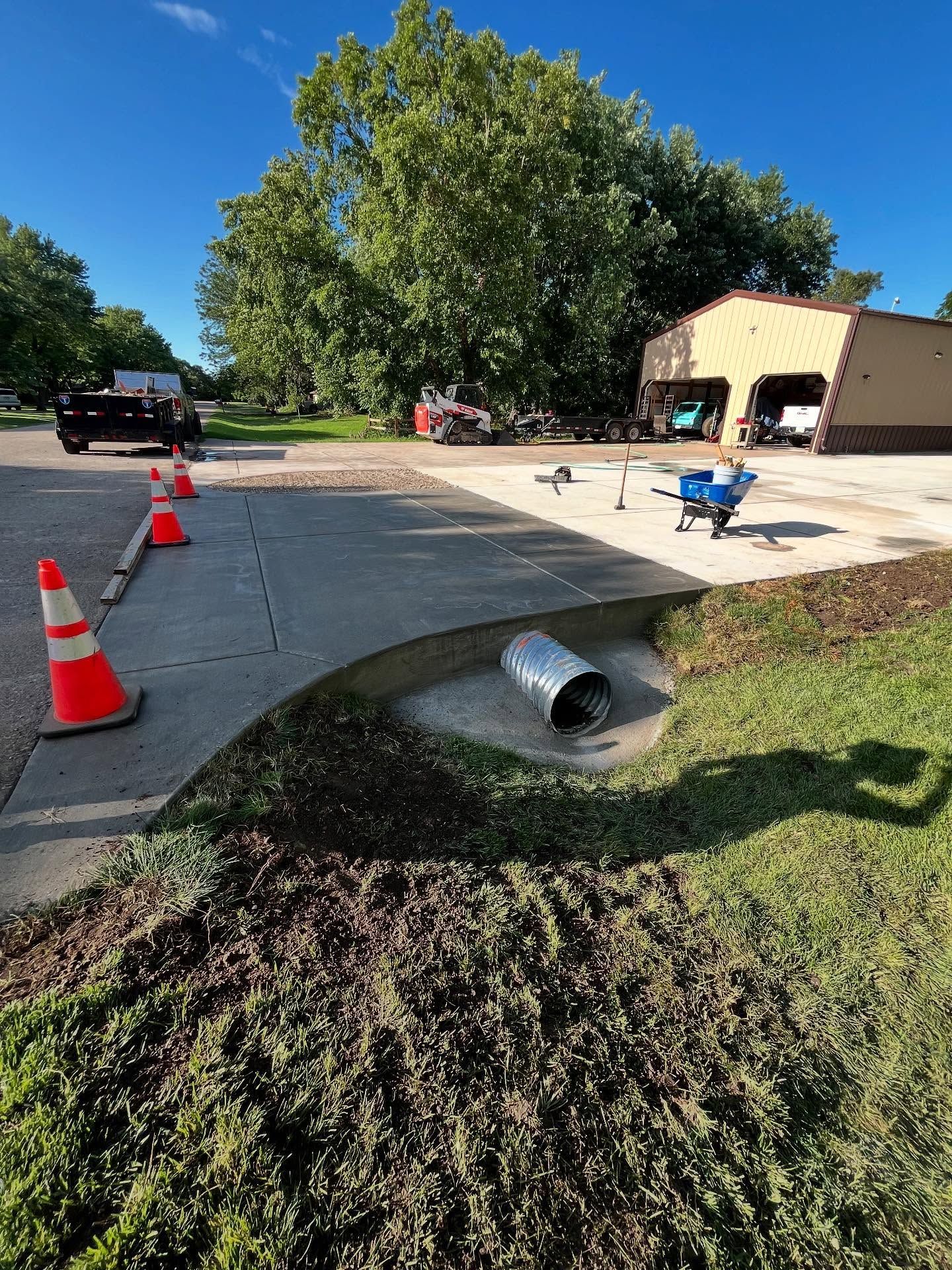 A large wooden deck with stairs is in front of a house at night.