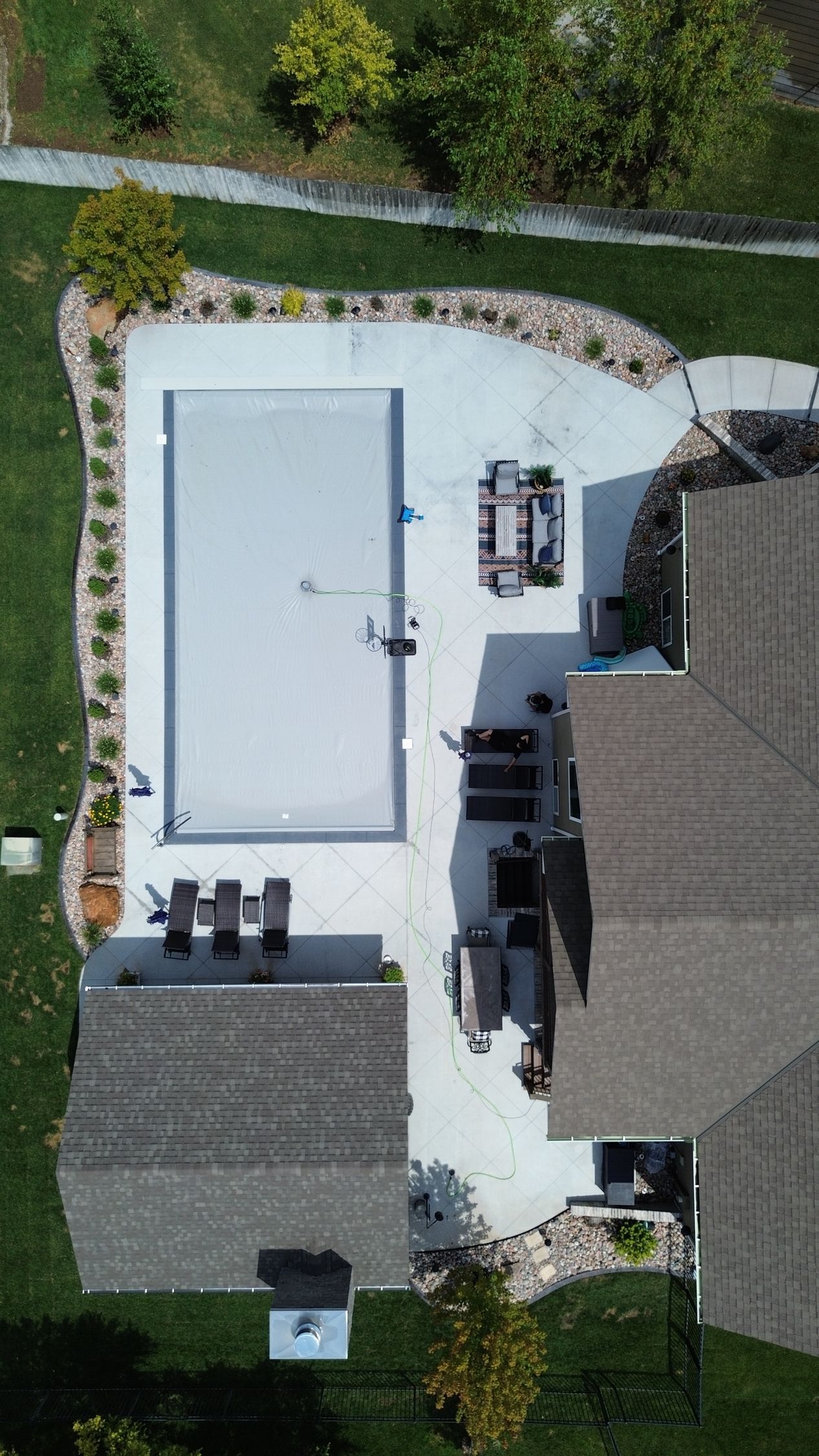A concrete patio is being built in front of a house.