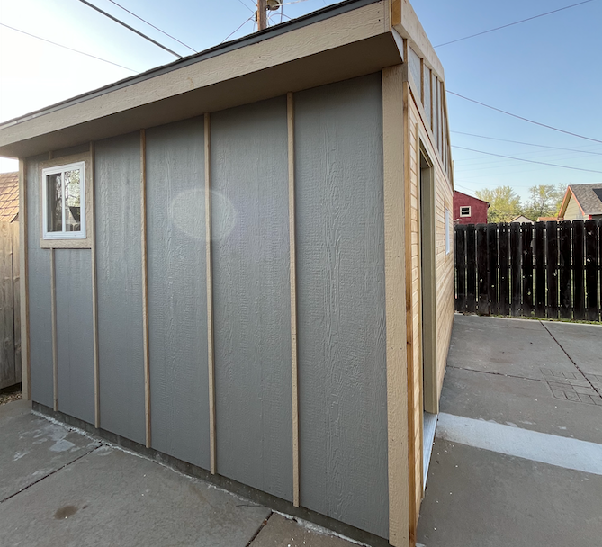 A shed with a window on the side of it