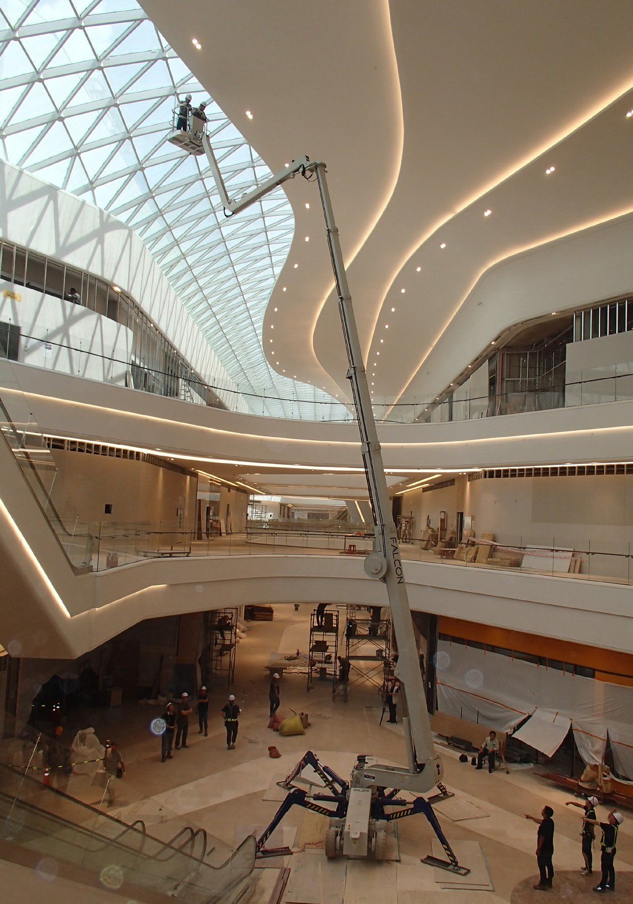 A large building under construction with a spider on the floor.