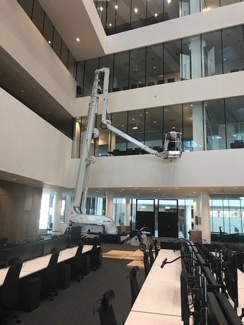 A large office building with a crane in the middle