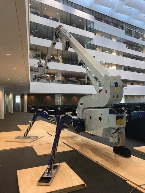 A crane is sitting in the middle of a large building